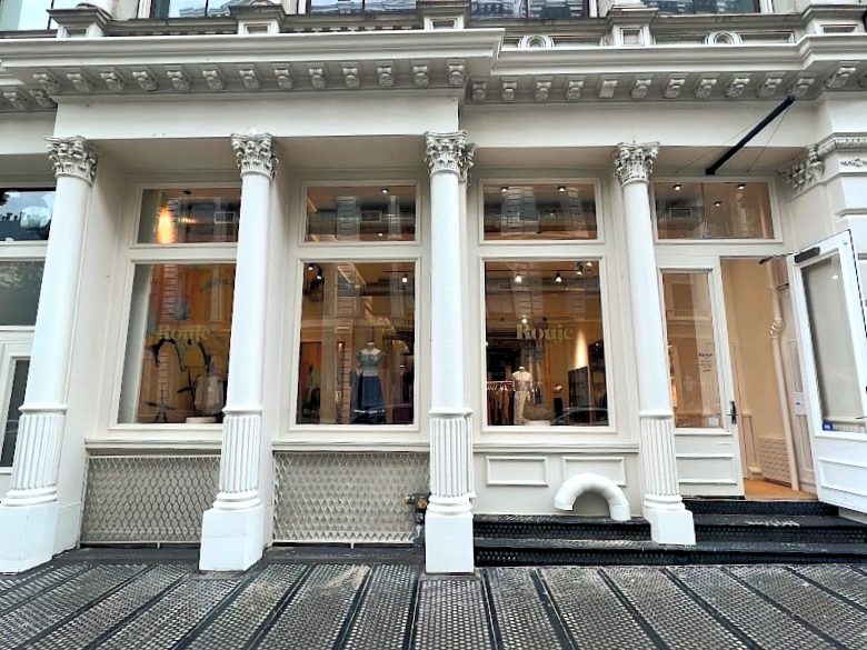 Restored cast-iron SoHo façade with painted columns, large s